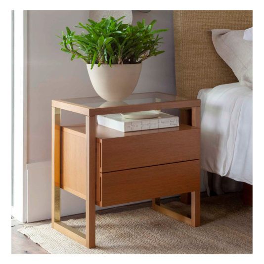Mesa de cabeceira moderna com planta decorativa.